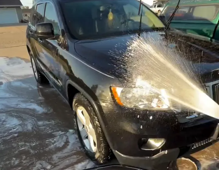 Black Jeep being rinsed during an exterior wash by González Auto Detailing
